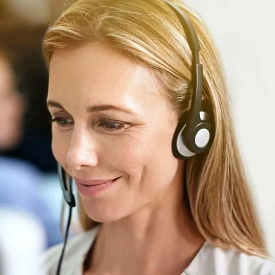 A woman in a headset, expertly handling customer inquiries in a virtual reception setting.